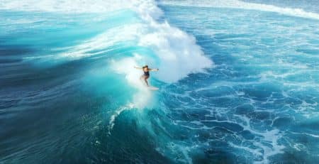 surfer-woman-riding-on-the-blue-ocean