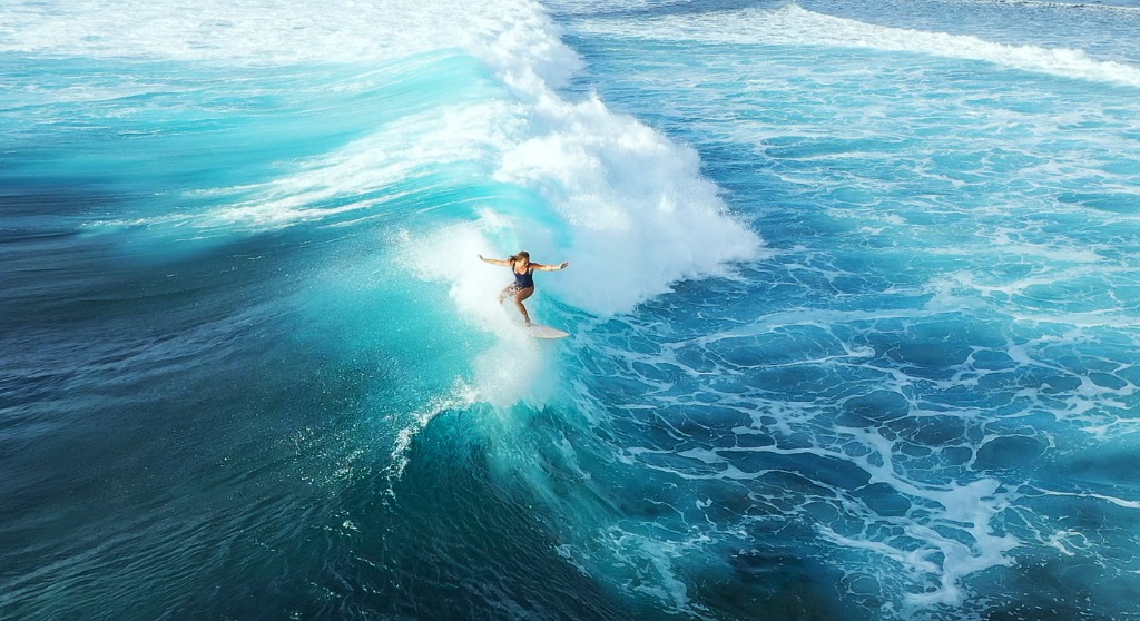 surfer-woman-riding-on-the-blue-ocean